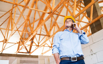 man in hardhat on the phone